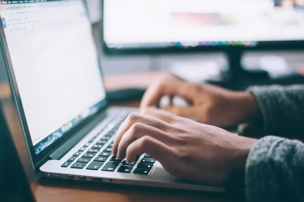 Modern web development workspace with laptop and code